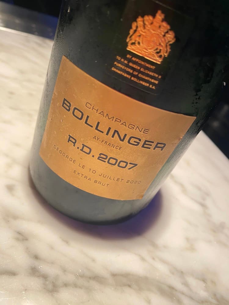 A bottle of Bollinger R.D. 2007 Extra Brut on a marble bar